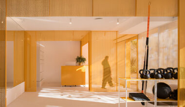 bright orange perforated metal sheets shape a modular fitness center in madrid