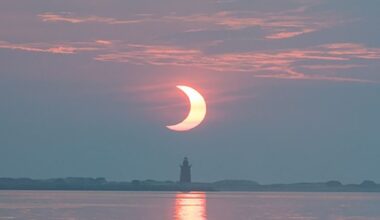 A partial solar eclipse rising behind Delaware Breakwater Lighthouse on at Lewes Beach in Delaware, USA, 10 June 2021. Credit: NASA/Aubrey Gemignani