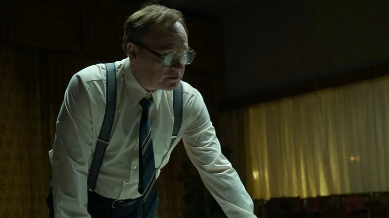 Jared Harris as Valery Legasov, leaning over a table intensely in Chernobyl.