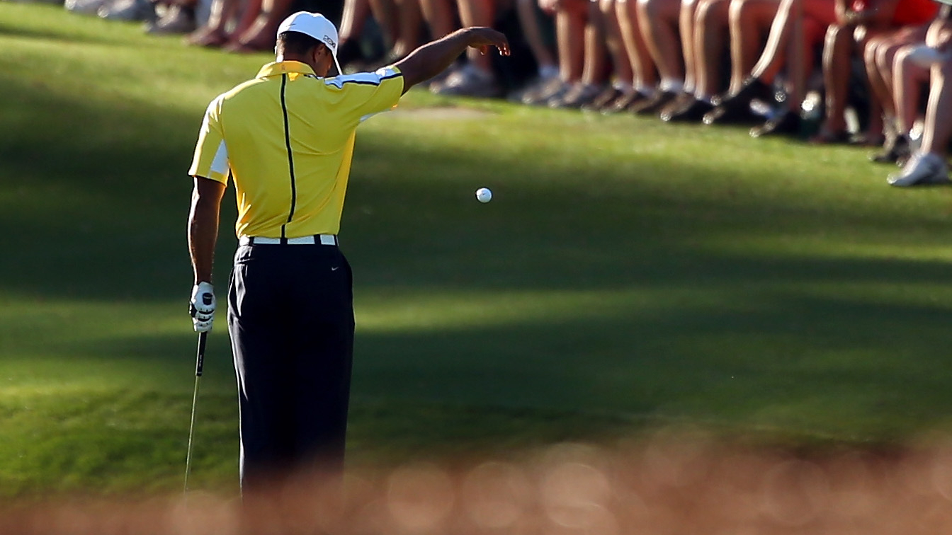 Tiger Woods drops his ball in the 2013 Masters
