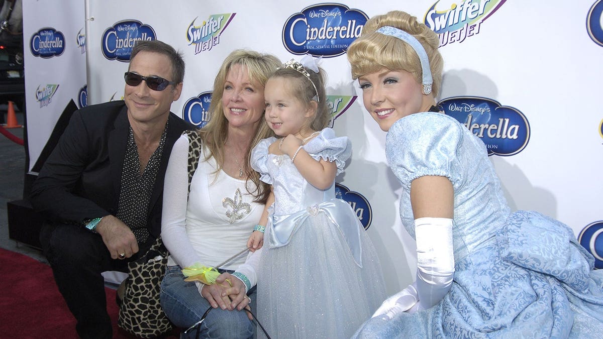 Clint Black, Lily Pearl, Lisa Hartman and Cinderella stand together.