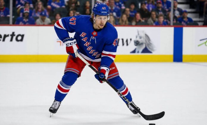 Connor Zary wearing a New York Rangers home jersey amid NHL trade rumors linking the Calgary Flames forward to New York