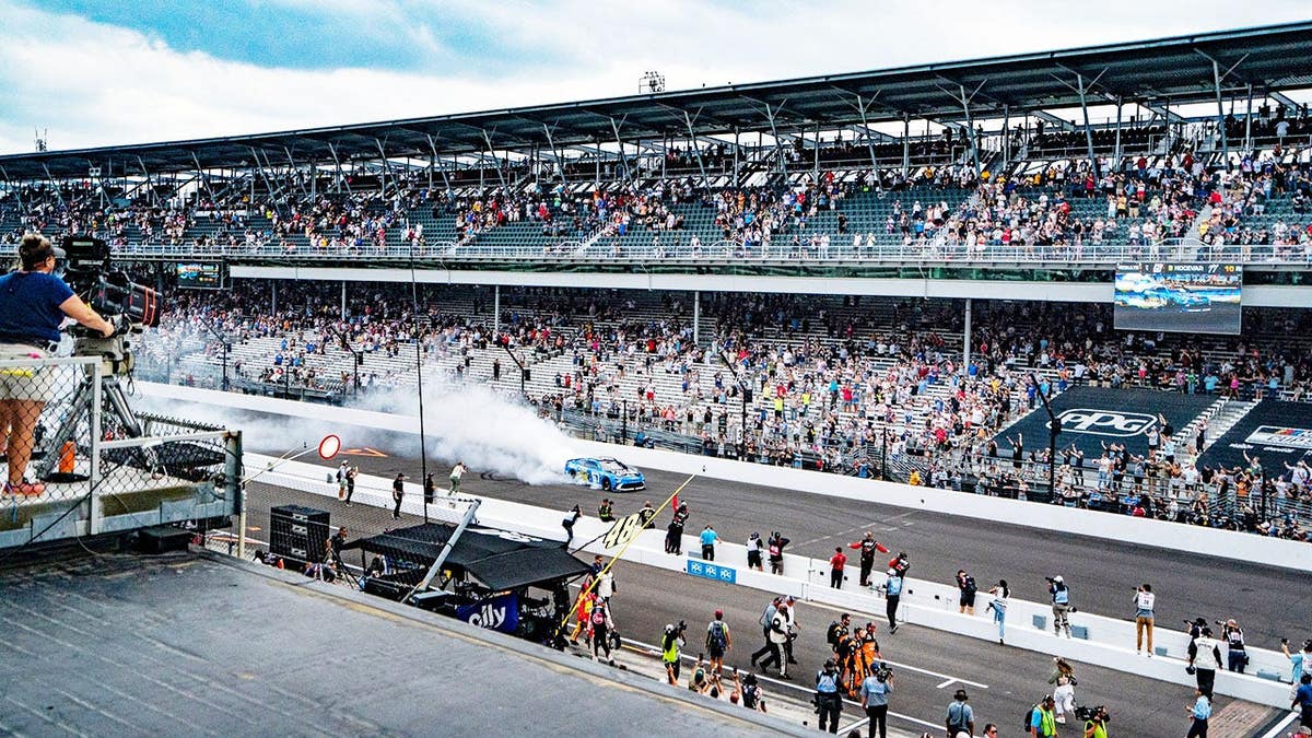 Corey Heim performs a burnout after winning the Brickyard 400 at Indianapolis Motor Speedway.
