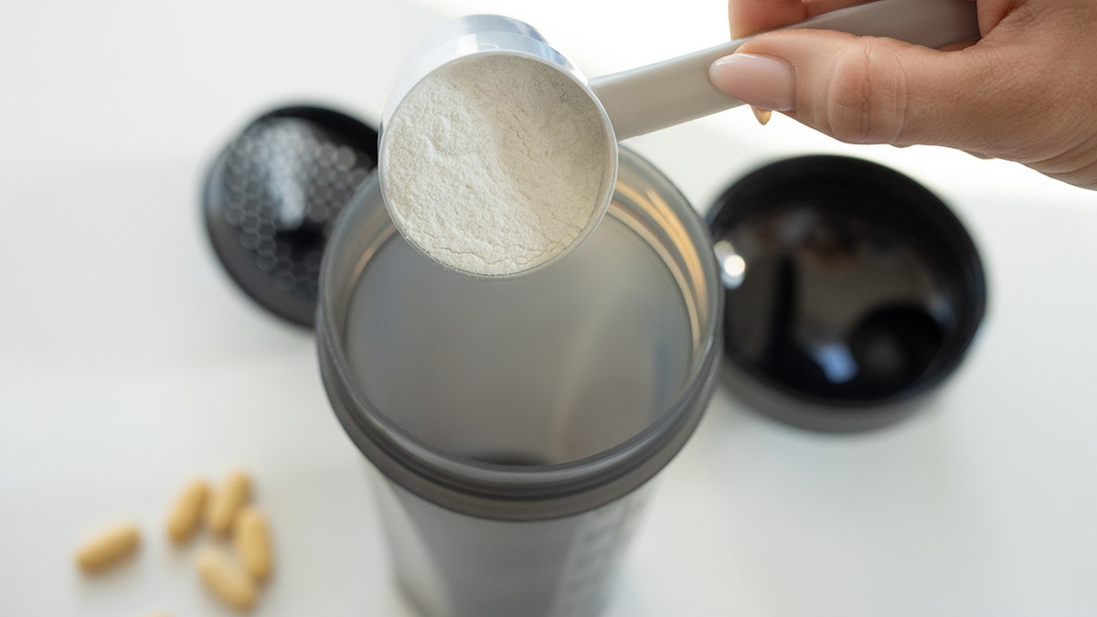 Creatine powder poured into a cup.