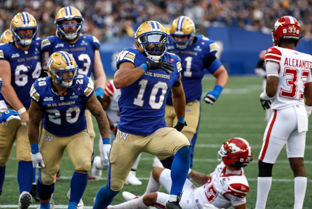 THE CANADIAN PRESS/John Woods
Winnipeg Blue Bombers' Nic Demski celebrates his first-half touchdown against the Calgary Stampeders in Winnipeg on Friday.