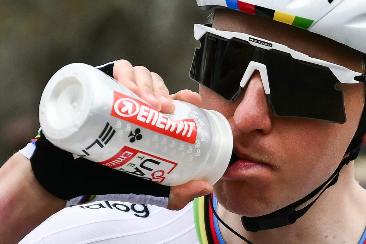 Tadej Pogačar drinking from bottle.