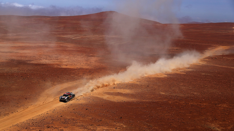 An aerial shot of a Mini John Cooper Works buggy car seen racing across the Peruvian desert during 2019 Dakar Rally