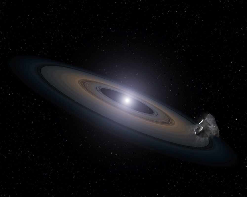 This artist's illustration shows a white dwarf surrounded by a debris disk. Astronomers are finding more and more white dwarfs with metallic debris disks, which suggests the debris comes from planetary systems. New research examines how white dwarfs accrete this debris, showing that it's much more common than thought, and that white dwarfs accrete more planetary debris than thought. Image Credit: NASA, ESA, and G. Bacon (STScI)