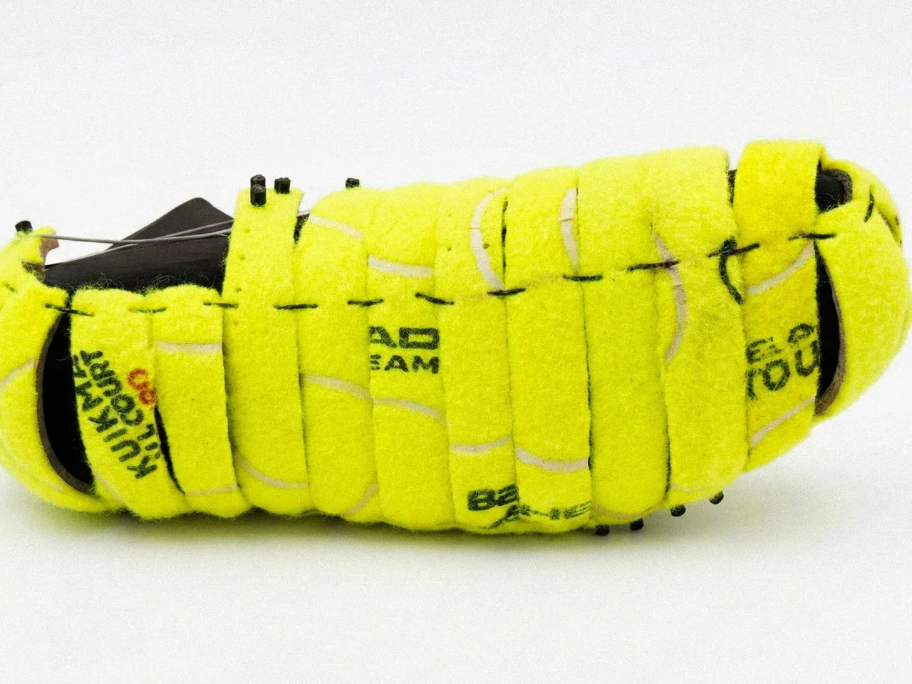 Close-up of a shoe sole made from green tennis ball material.