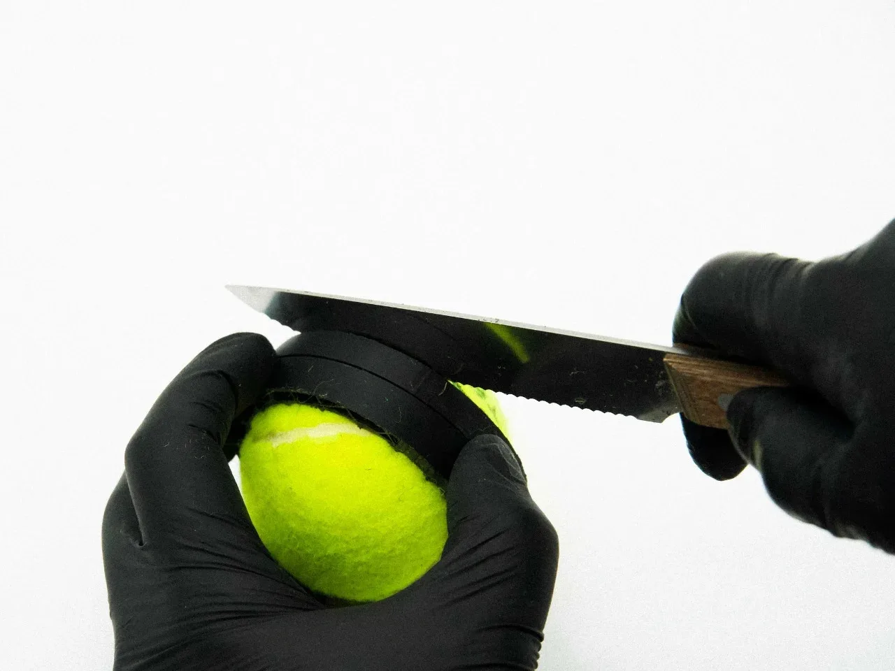 Designer sewing shoe mockup using recycled tennis ball fabric.