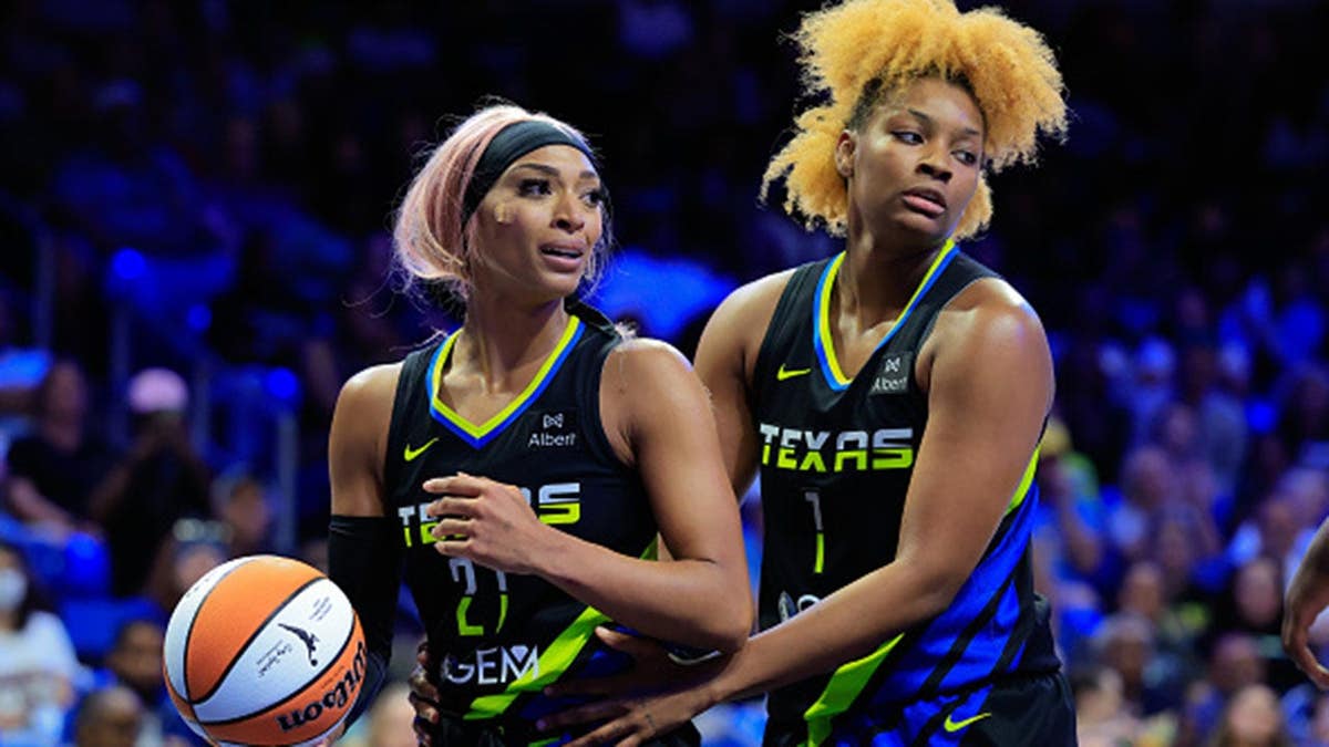 DiJonai Carrington is held by NaLyssa Smith during a WNBA game.