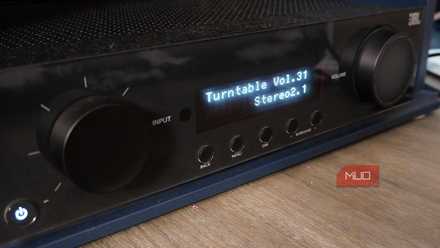 A Dolby Atmos receiver showing the display and dials.