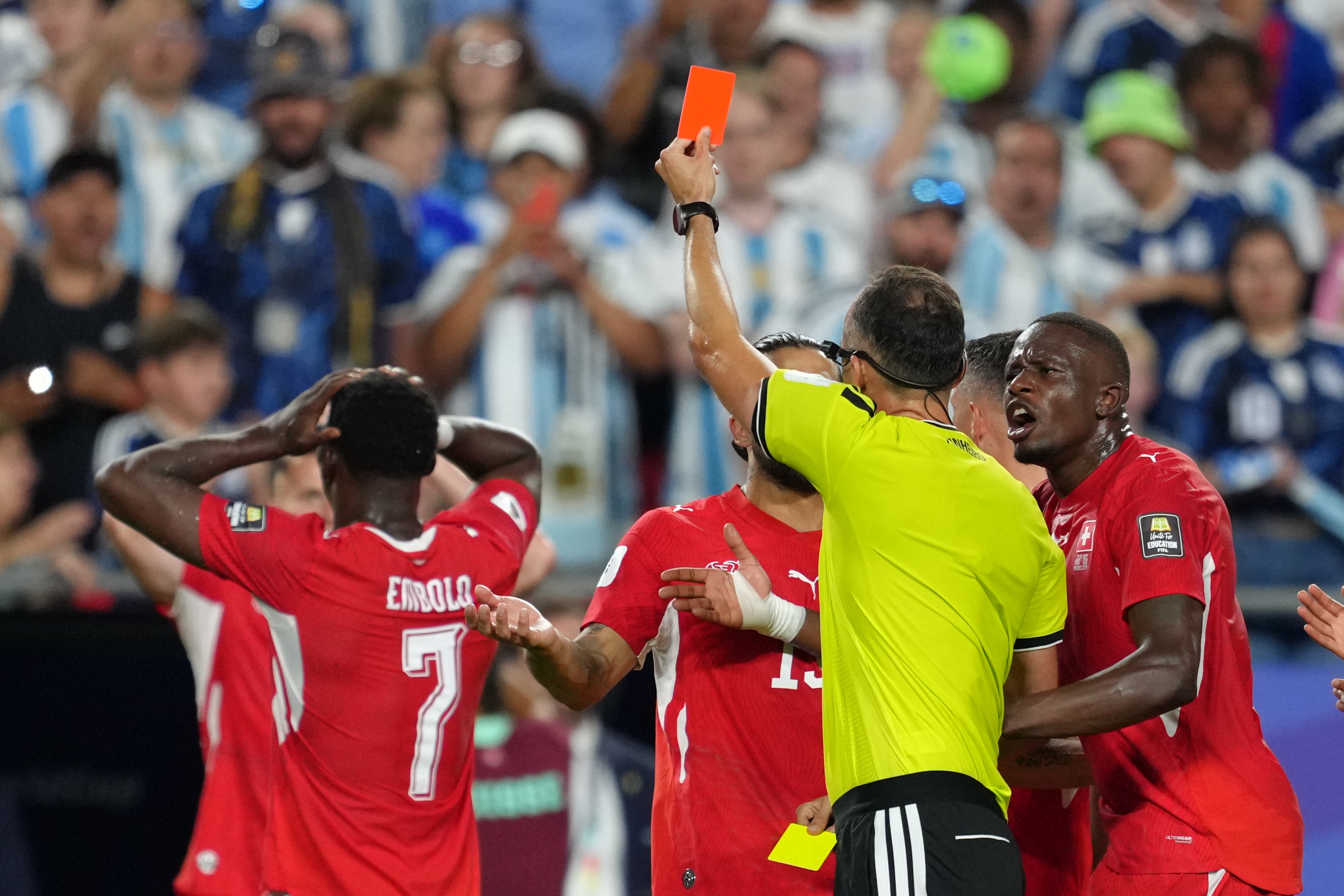 Referee Joao Pinheiro, of Portugal, gives a red card for Switzerland's Breel Embolo (7)