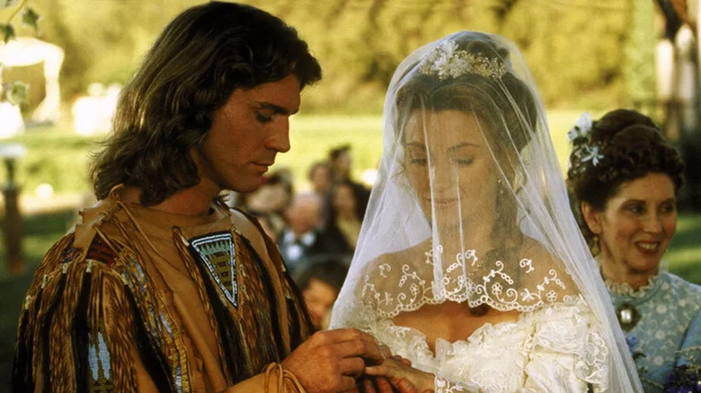 Bryon Sully (Joe Lando) puts a wedding ring on Michaela Quinn (Jane Seymour) during their wedding in Dr. Quinn, Medicine Woman