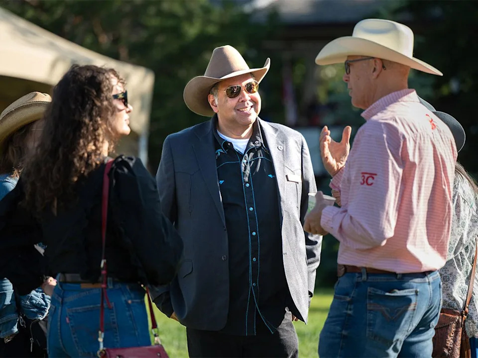 Alberta NDP Leader Naheed Nenshi speaks with attendees of the Legacy Stampede Breakfast at Heritage Park in Calgary on Sunday, July 5, 2026.