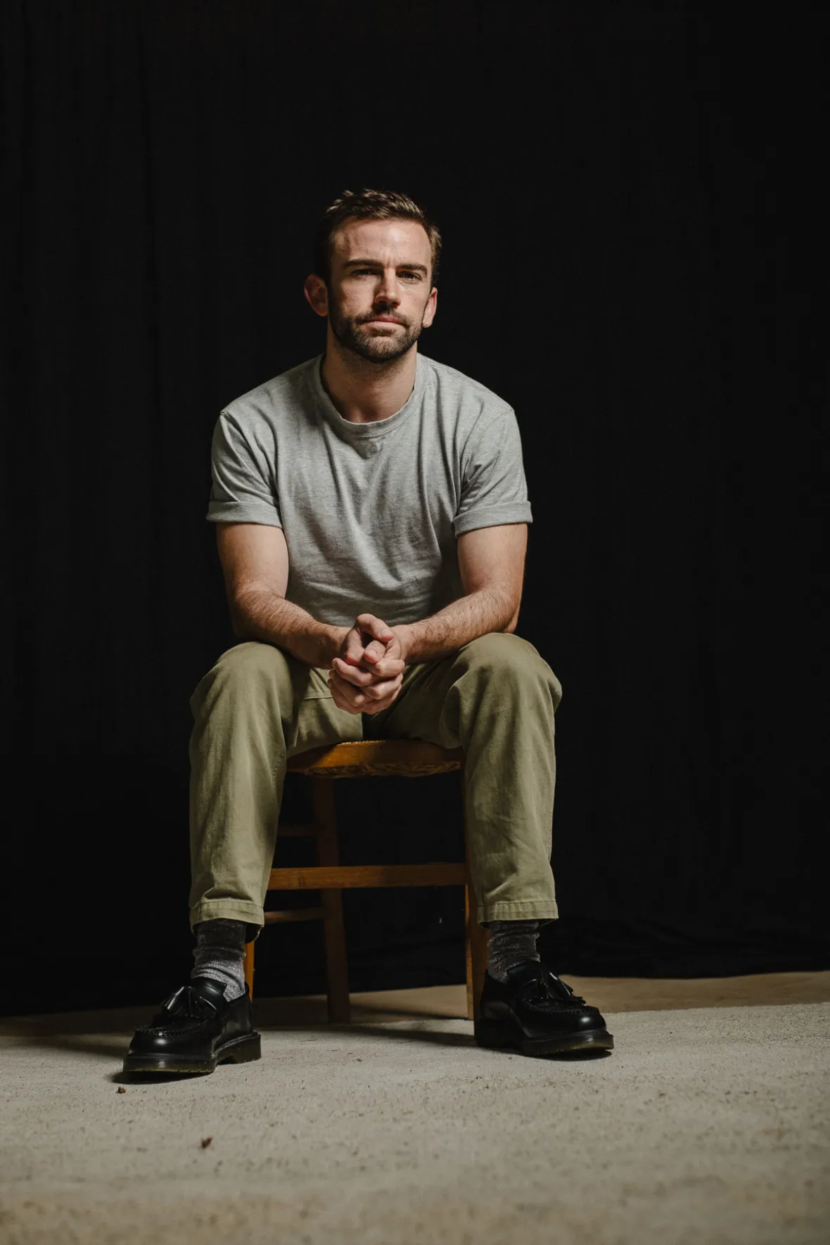 Christian Tucci seated against a black background.