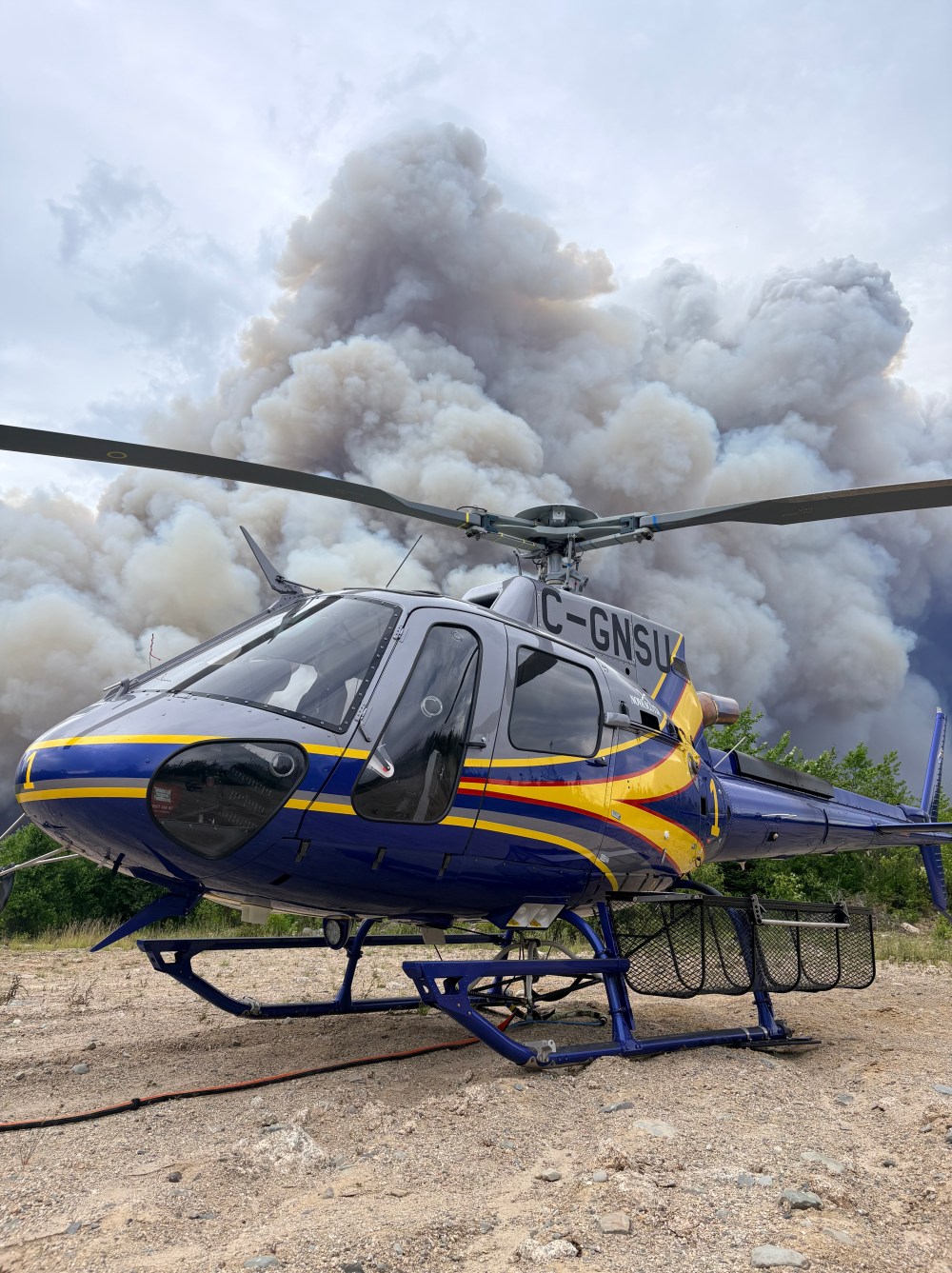 Smoke from the Mooseland Road wildfire, about 100km northeast of Halifax, is shown behind a helicopter in this handout photo on Thursday, July 16, 2026. THE CANADIAN PRESS/Handout — N.S. Department of Natural Resources (Mandatory Credit)