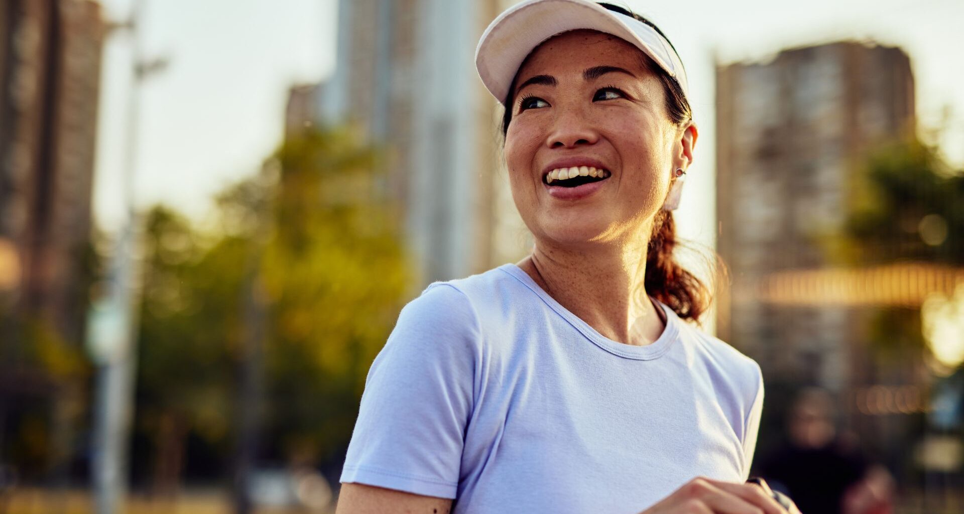 Woman laughing after playing tennis, smiling