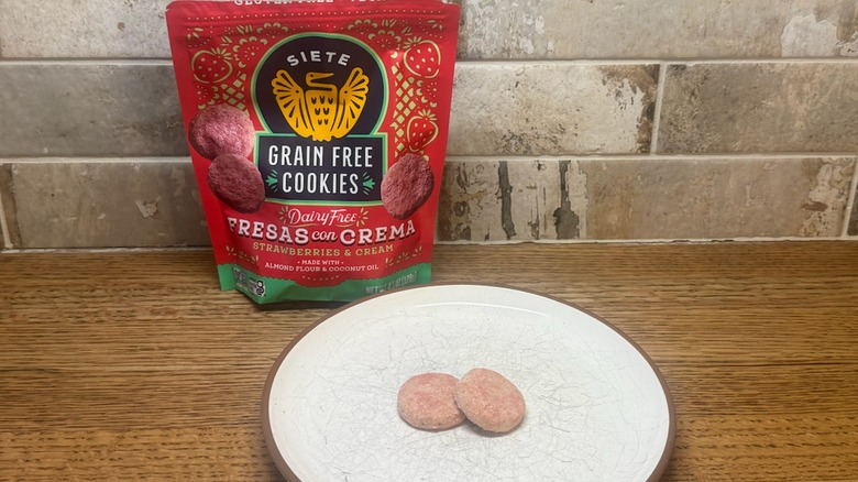 Siete Strawberries And Cream cookies on a white plate with the bag in the background