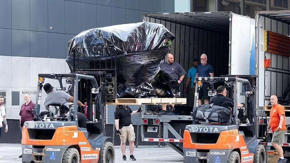Crew members are seen unloading trucks and transporting large boxes and items under tarpaulin into Madison Square Garden in preparation for the rumoured wedding of Taylor Swift and Travis Kelce