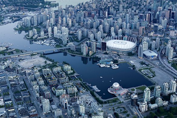 Vancouver from the air – the bigger stadium with the white roof is World Cup venue BC Place; Rogers Arena is the smaller stadium to its right.