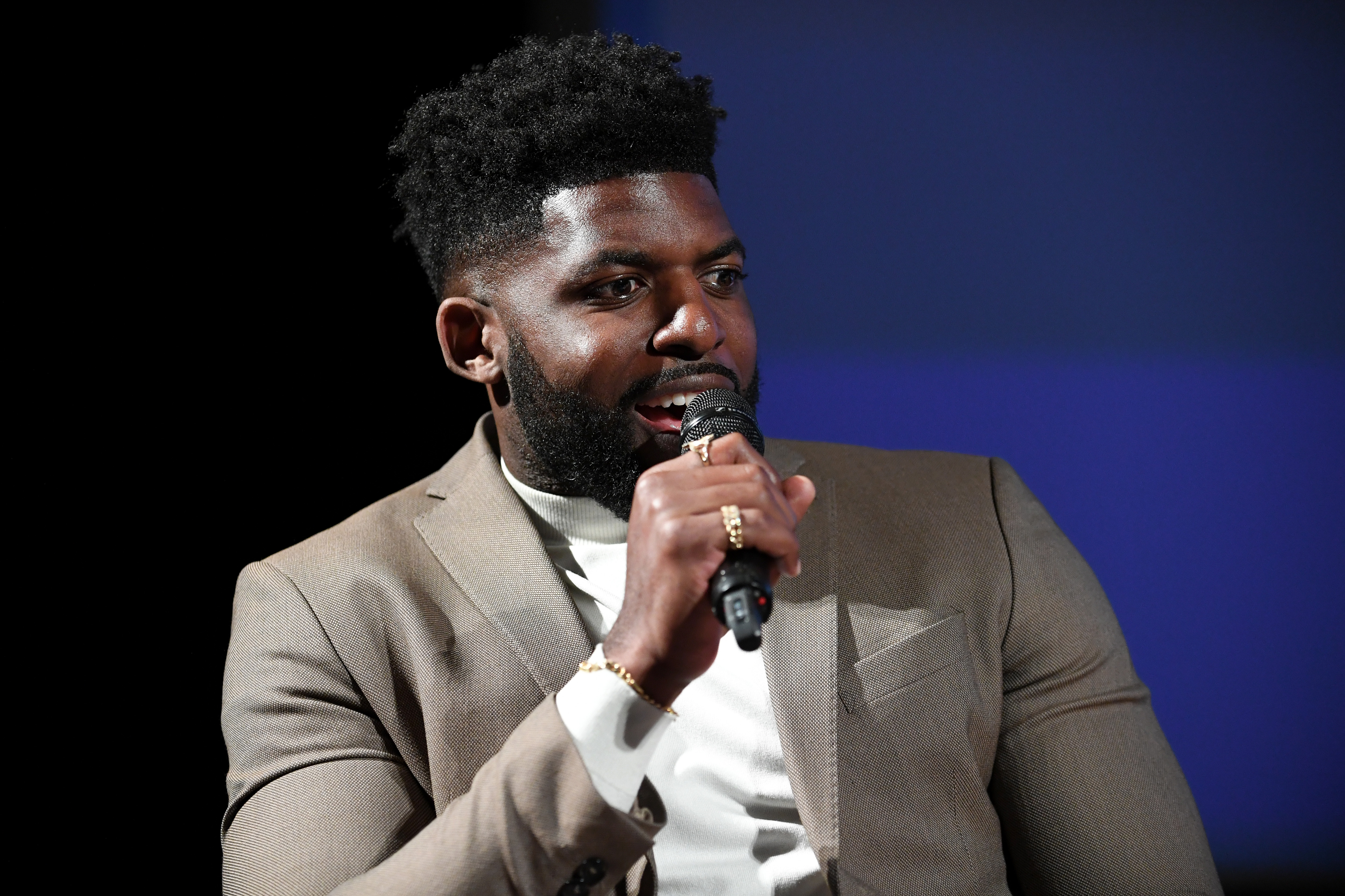 Emmanuel Acho speaking onstage at a screening event at Paramount Studios in Los Angeles