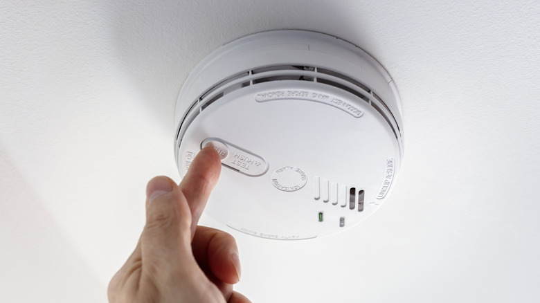 A smoke and fire alarm attached to the ceiling