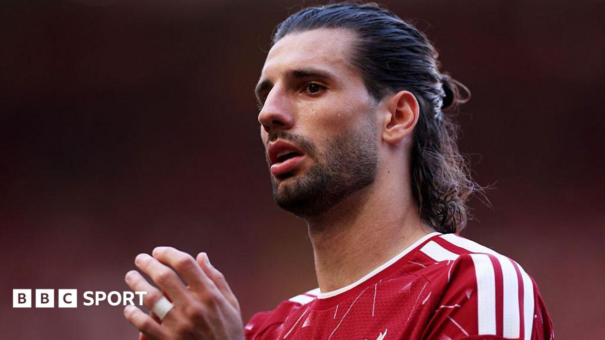 Dominik Szoboszlai claps in a Liverpool shirt