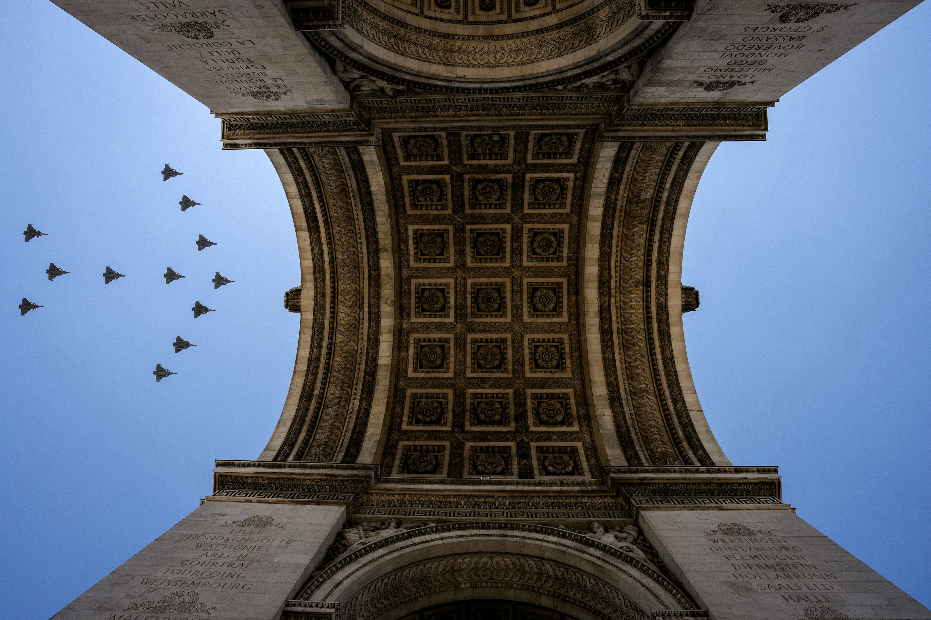 TOPSHOT - Rafale fighter jets fly over the Arc de Triomphe during a rehearsal, ahead of the Bastille Day parade on the Champs-Elysees avenue in Paris on July 9, 2026. (Photo by Dimitar DILKOFF / AFP via Getty Images)