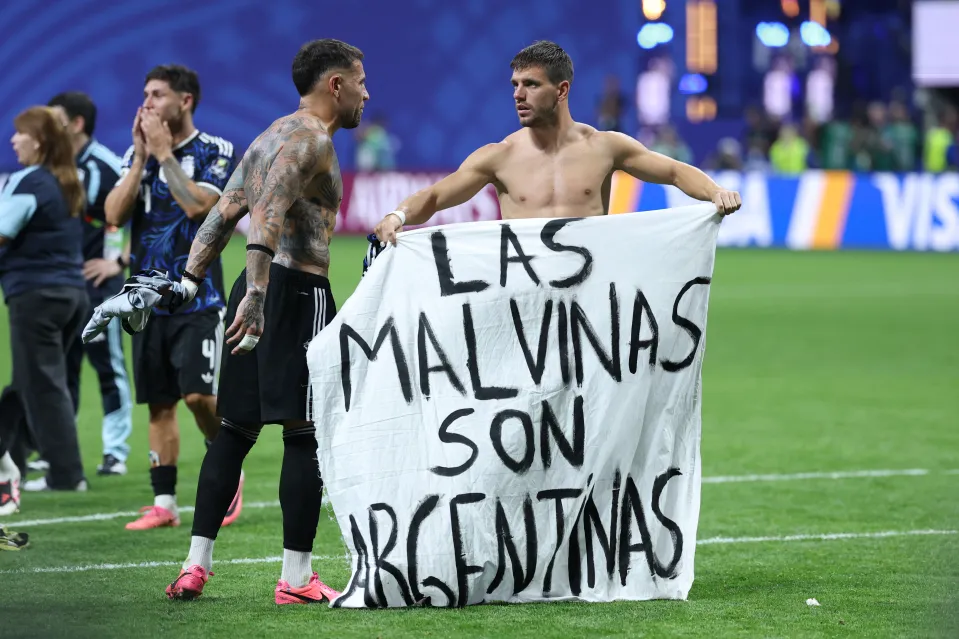 Argentina players hold up the Falklands banner