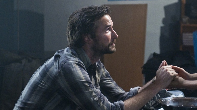Tom Mason (Noah Wyle) holding someone's hand on "Falling Skies."