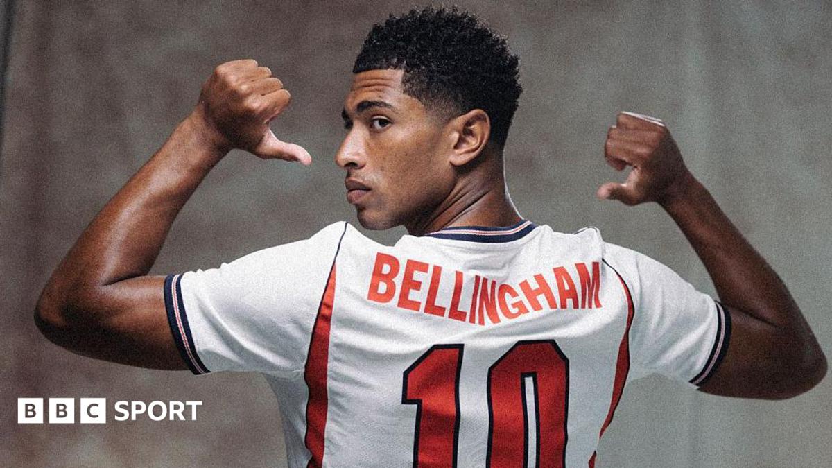 A picture of Jude Bellingham in a publicity shot wearing an England shirt, staring at the camera.