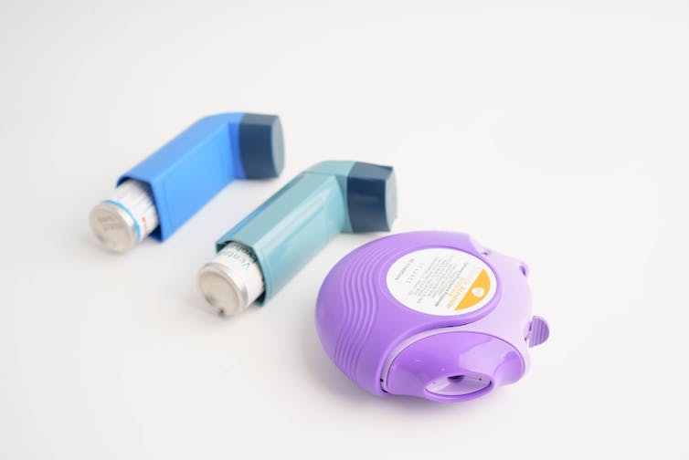 Three different asthma inhalers.