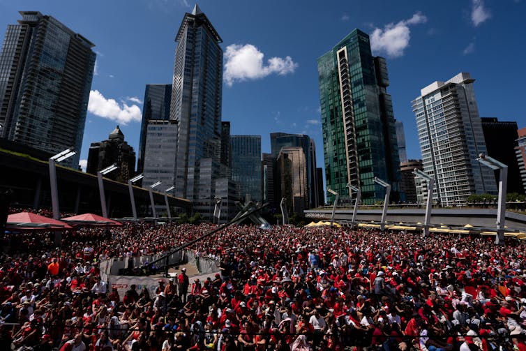 A massive crowd of people decked out in white and red