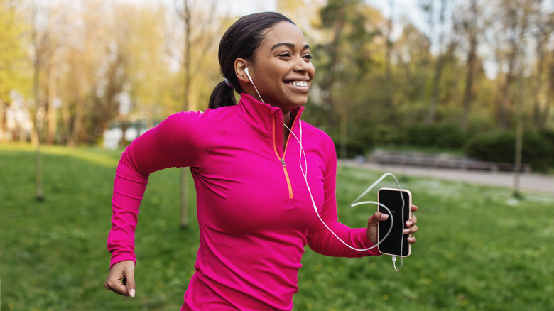 A person running with their phone in their hand