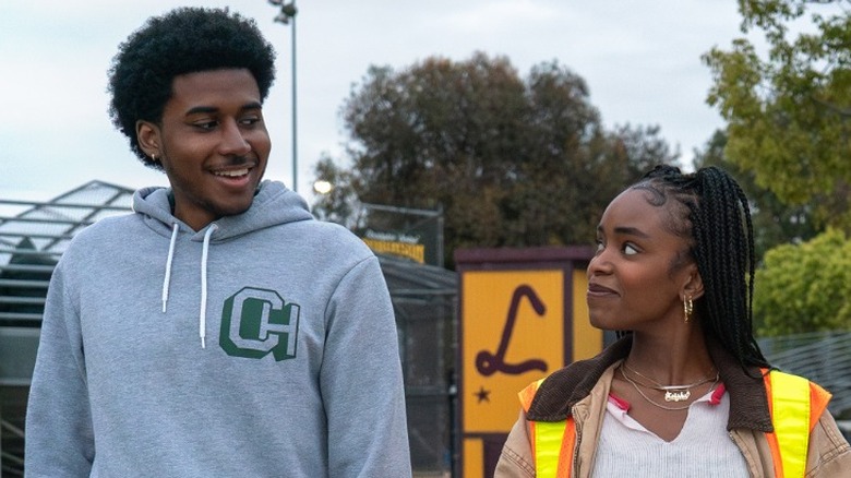 Justin Edwards walking on the high school field next to Keisha Clark in Forever