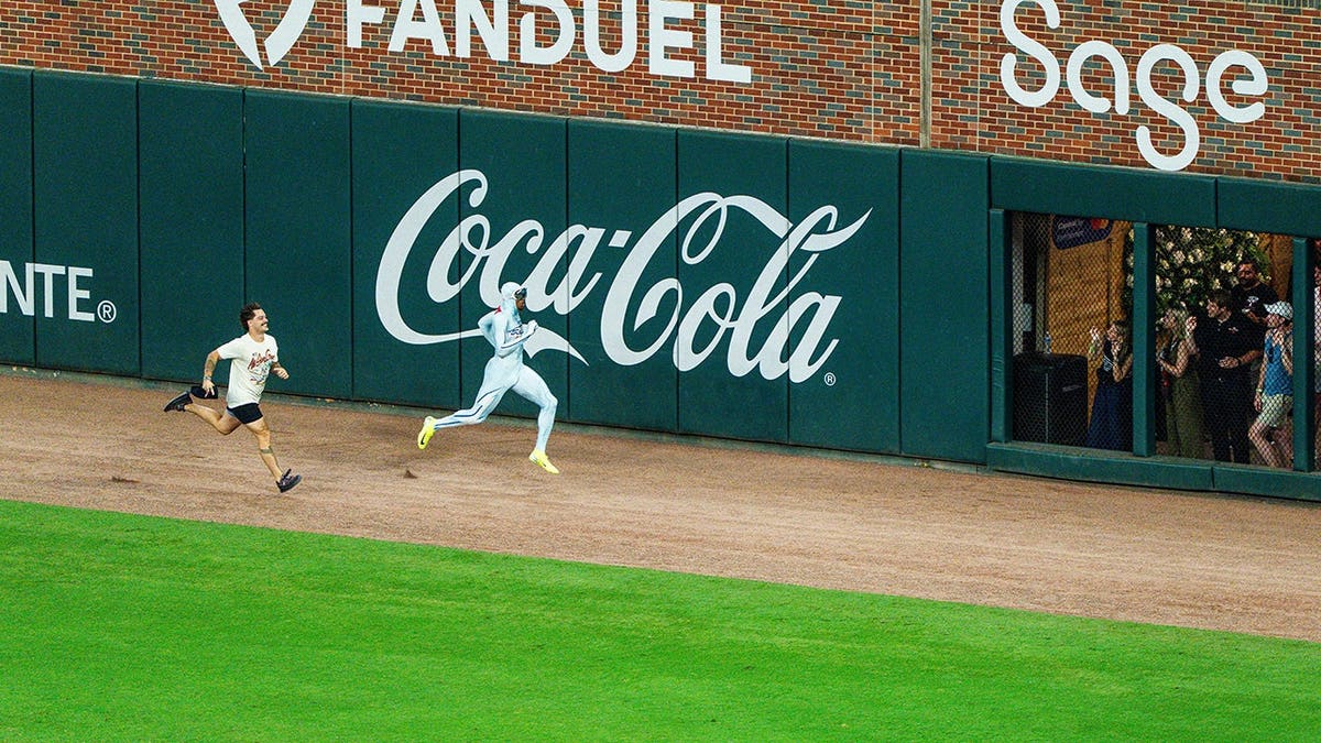 The Freeze races a fan during the All-Star Game at Truist Park.