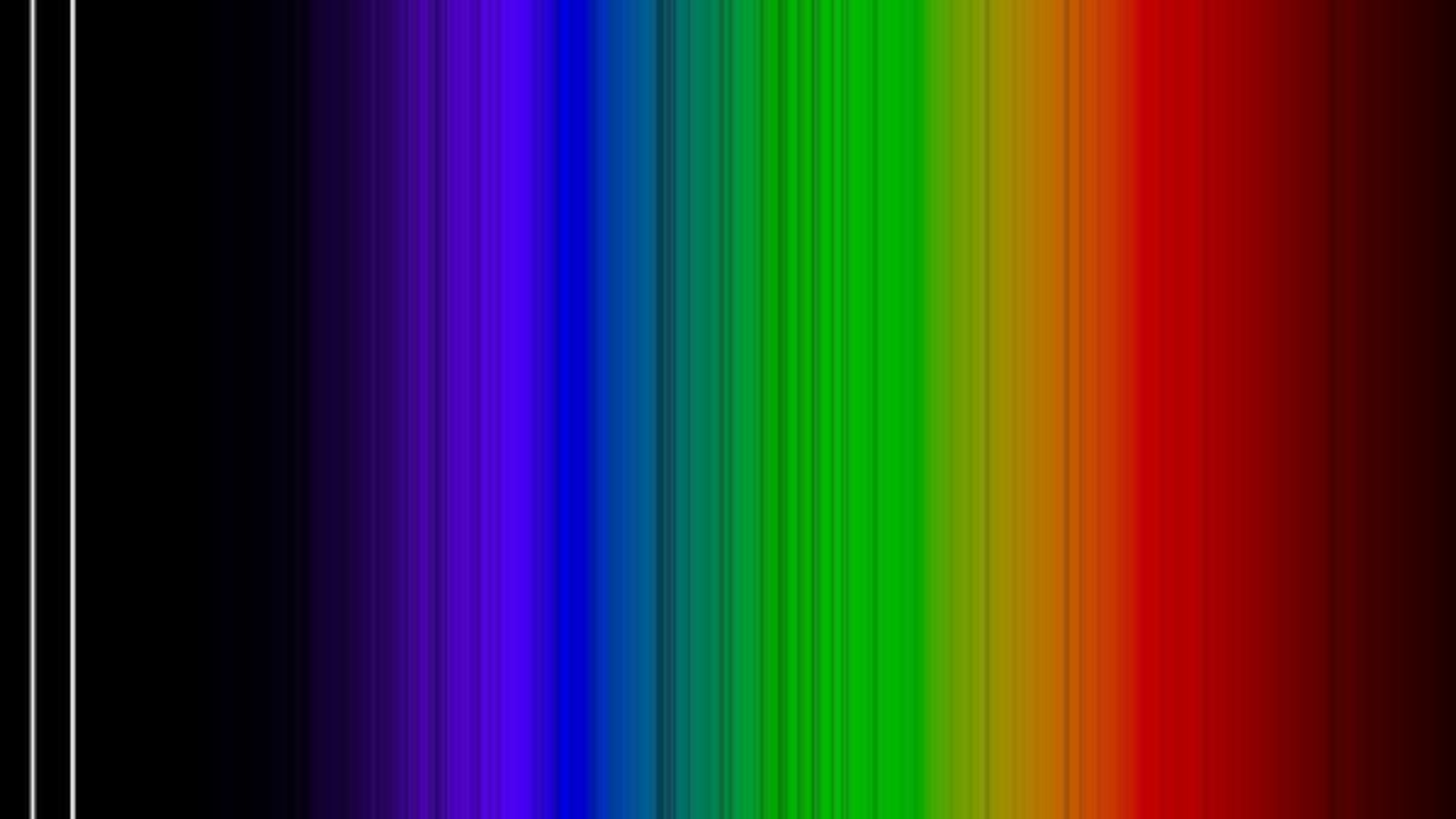 A rainbow assortment of spectral lines. On the left, where it's dark, there are two vertical white lines.