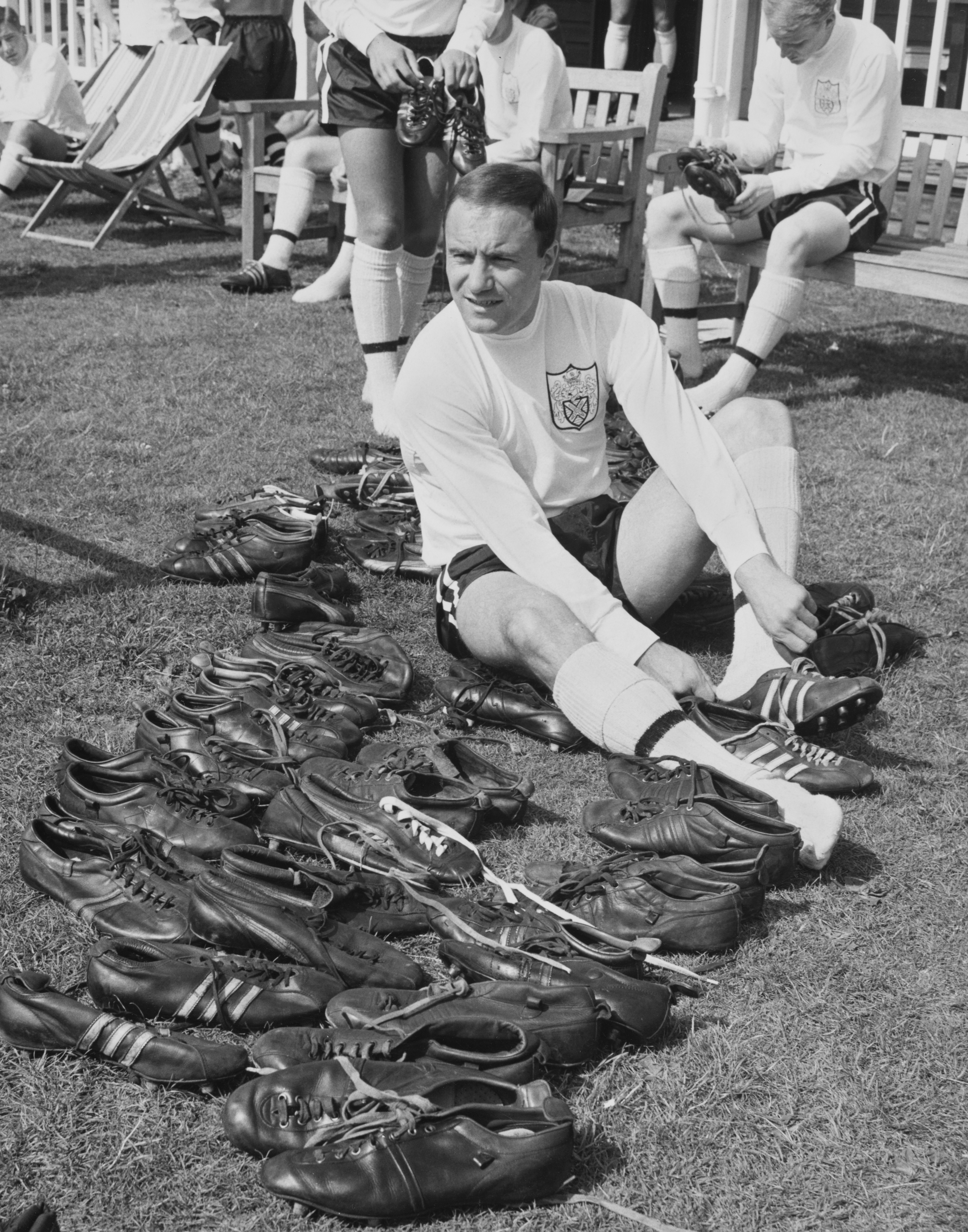 George Cohen, Right Back for Fulham Football Club sorting out a pair of football boots during a training session on 26th July 1967 at the Fulham training ground in Ewell, Surrey, England. Cohen was a squad member of the England team that won the 1966 World Cup. (Photo by William Vanderson/Fox Photos/Hulton Archive/Getty Images).