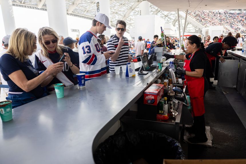 Fans buy snacks and beverages at a concession stand during the 2026 World Cup football match between USA and Paraguay at the Los Angeles Stadium in Inglewood, California, on June 12, 2026.