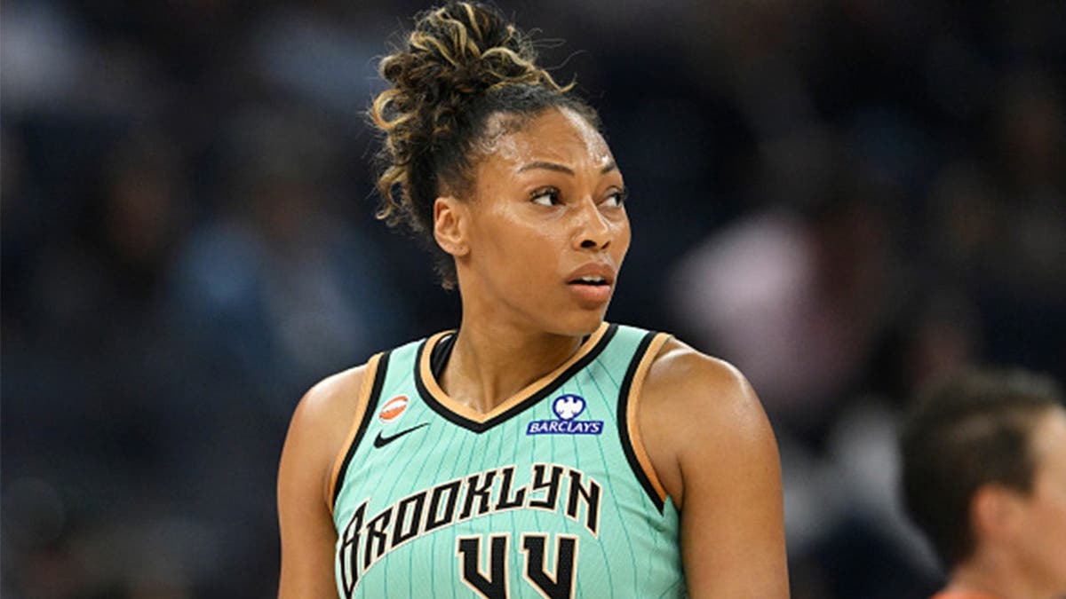Betnijah Laney-Hamilton throws Jonquel Jones' shoe down the court, accidentally striking Marina Mabrey during Sunday's WNBA game.