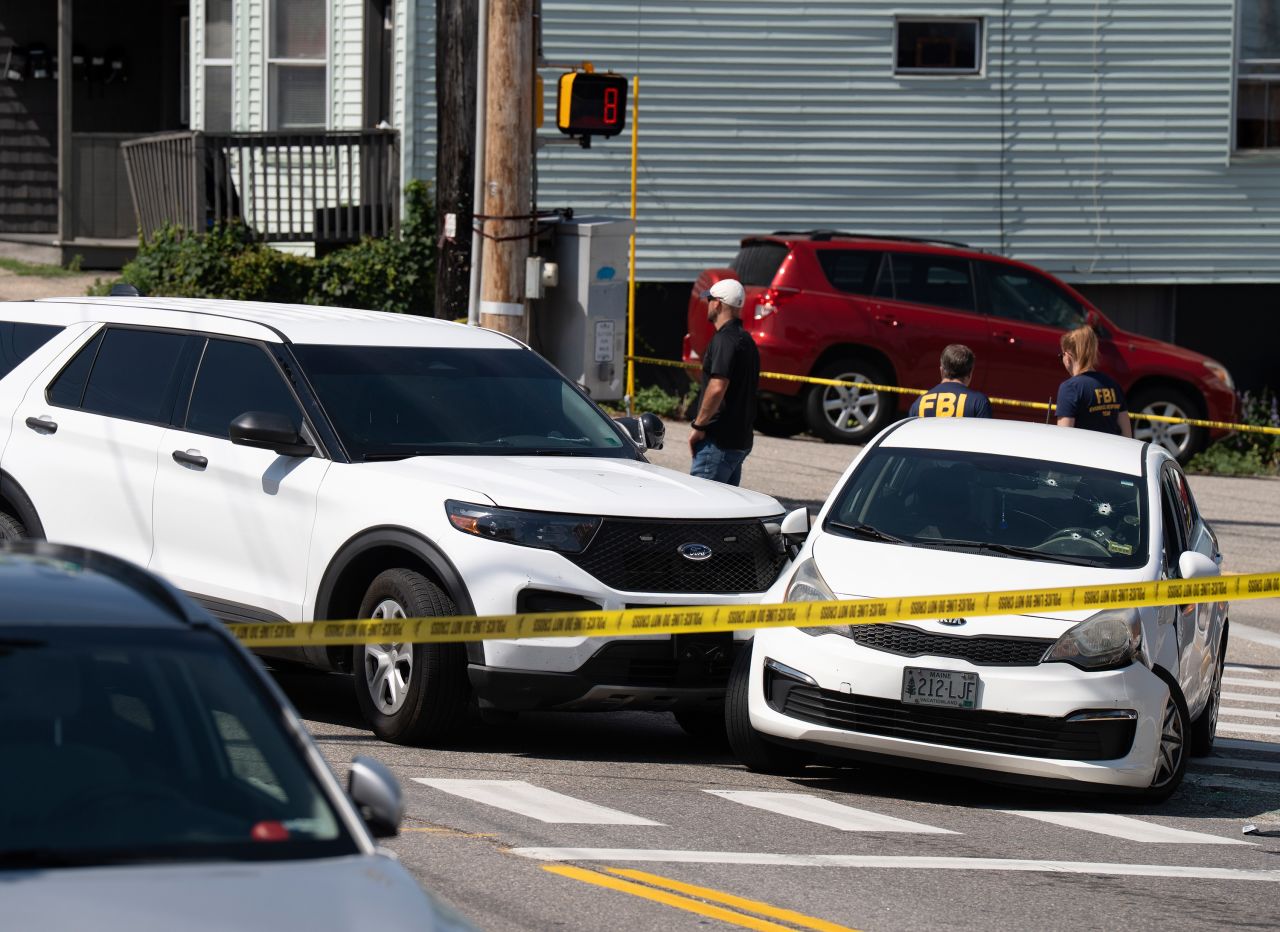 A Kia sedan reportedly driven by the victim of a fatal shooting can be seen with four bullet holes in the windshield at the scene on Pool Street in Biddeford on Monday.