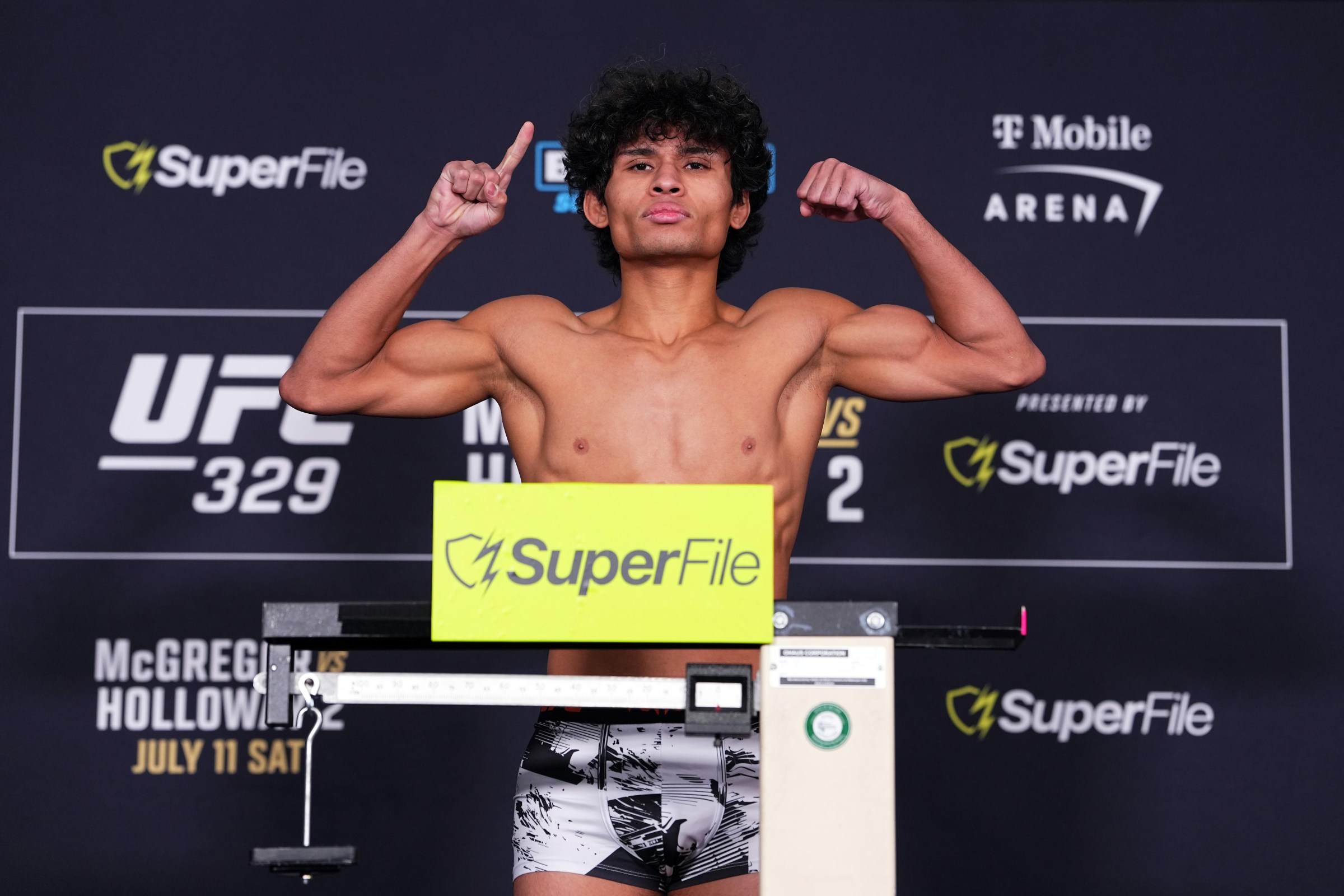 LAS VEGAS, NEVADA - JULY 10: John Garza poses on the scale during the UFC 329 official weigh-in at T-Mobile Arena on July 10, 2026 in Las Vegas, Nevada. (Photo by Jeff Bottari/Zuffa LLC)