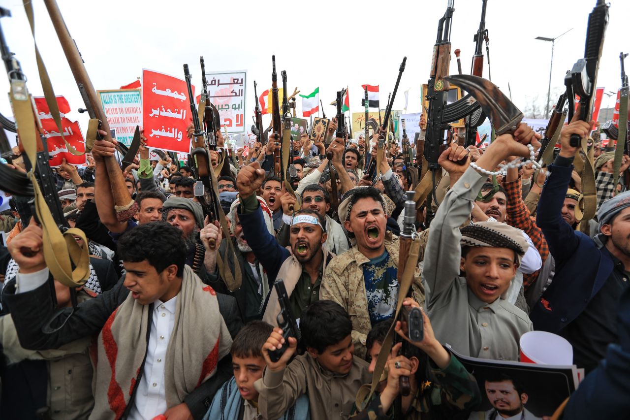 Armed Yemeni supporters of the Iran-backed Houthi movement brandish weapons during a protest against what the group says are restrictions imposed by the Saudi-led coalition on Houthi-controlled areas of Yemen on July 17.