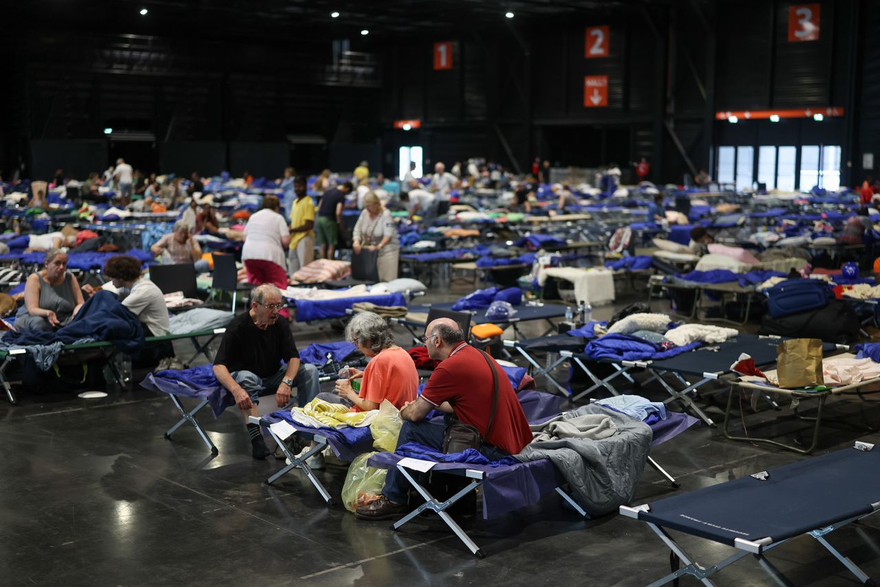 Cots are lined up in a vast space at an exhibition hall serving as an evacuation shelter during the wildfire in Bordeaux, France, on Monday.