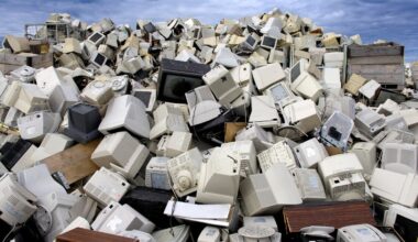 A pile of computers and monitors