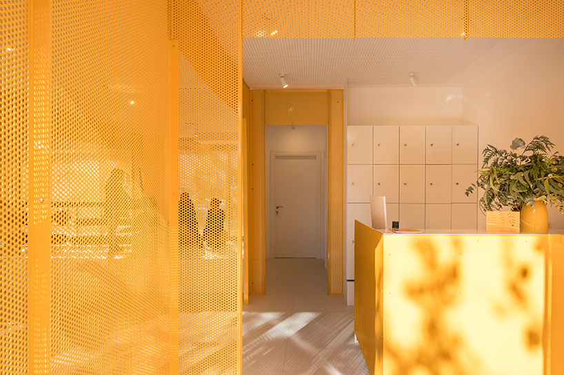 bright orange perforated metal sheets shape a modular fitness center in madrid - 1