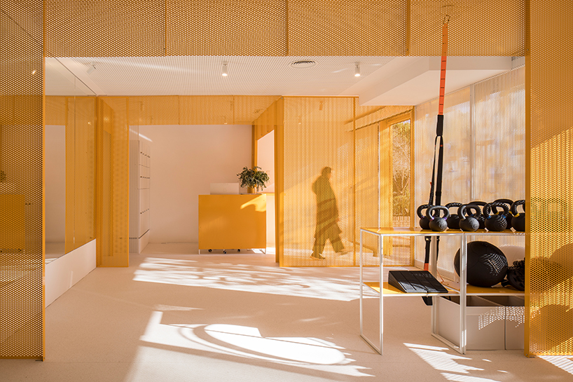 bright orange perforated metal sheets shape a modular fitness center in madrid - 2
