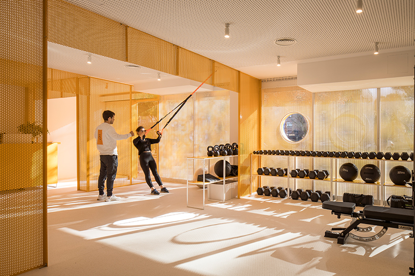 bright orange perforated metal sheets shape a modular fitness center in madrid - 3