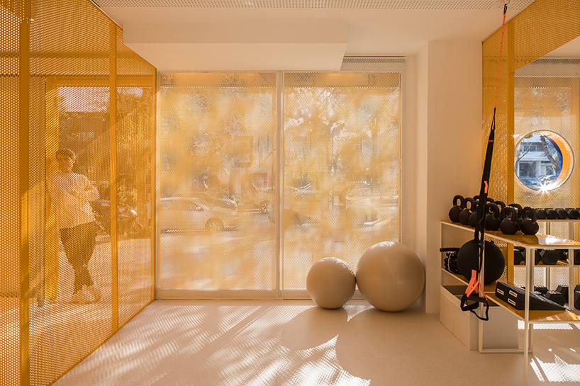 bright orange perforated metal sheets shape a modular fitness center in madrid - 5